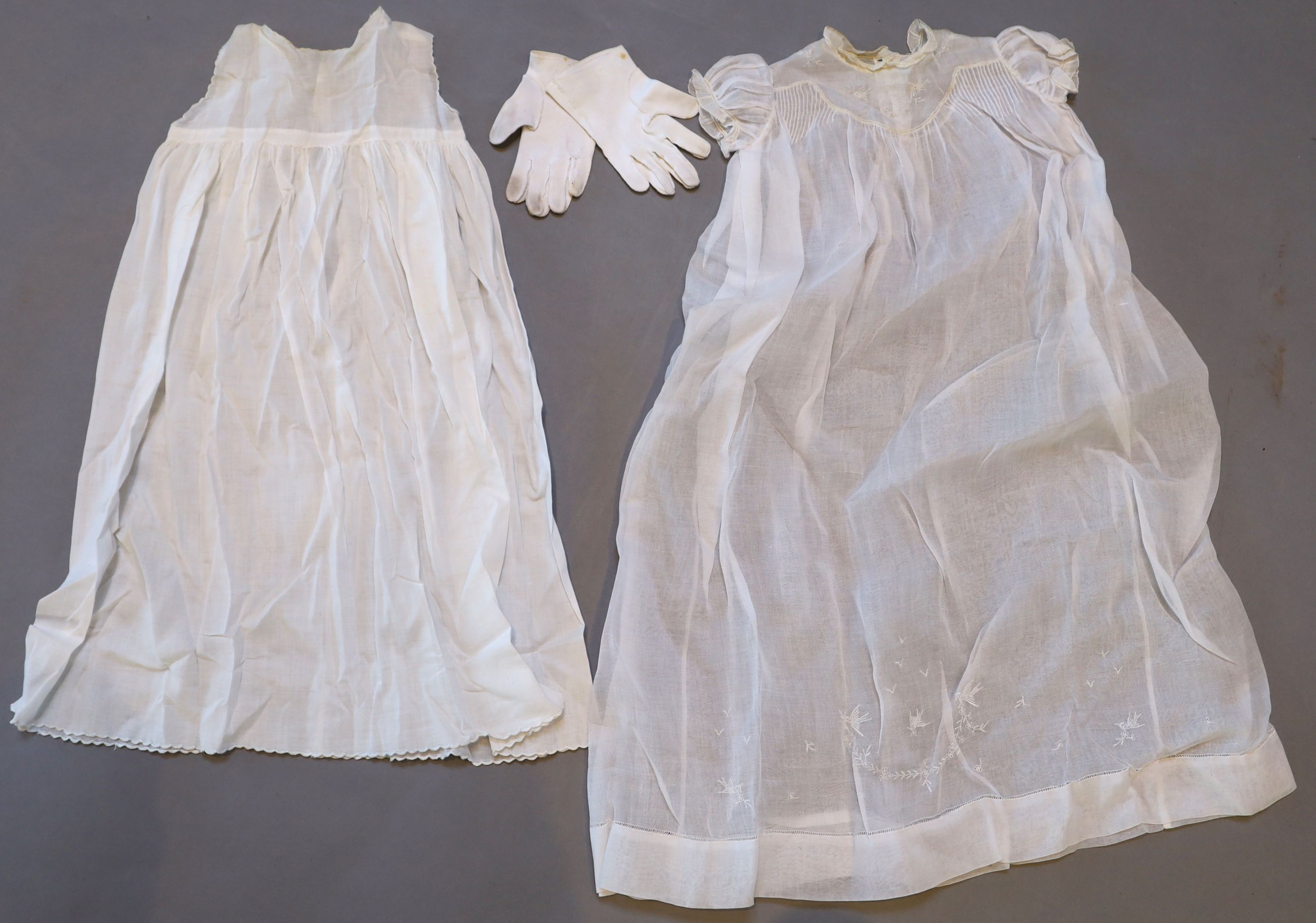 A collection of embroidered whitework christening robes